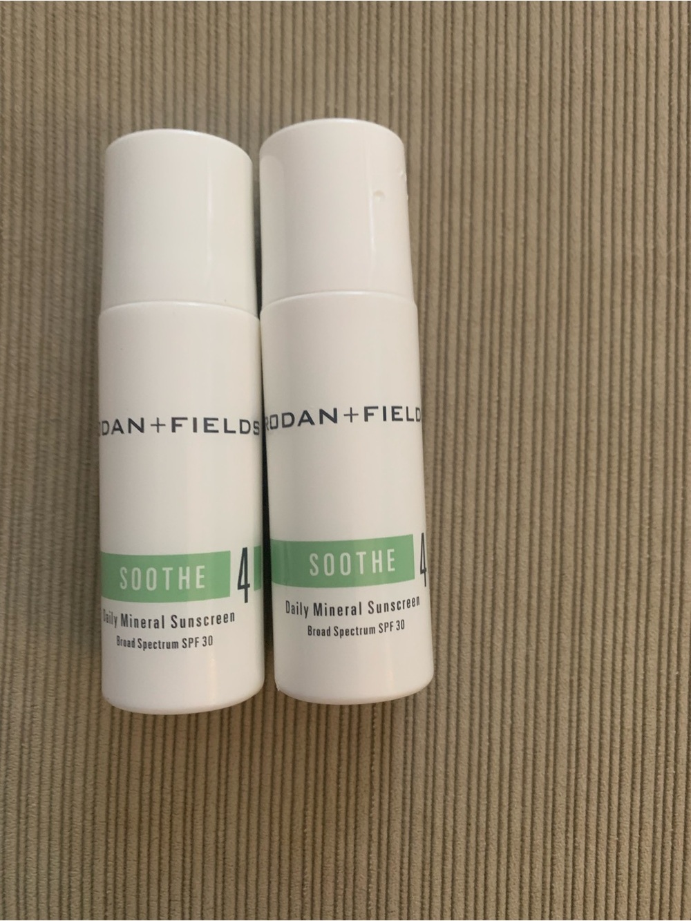 Rodan + Fields Soothe Daily Mineral Sunscreen Bottles - White & Green Accents